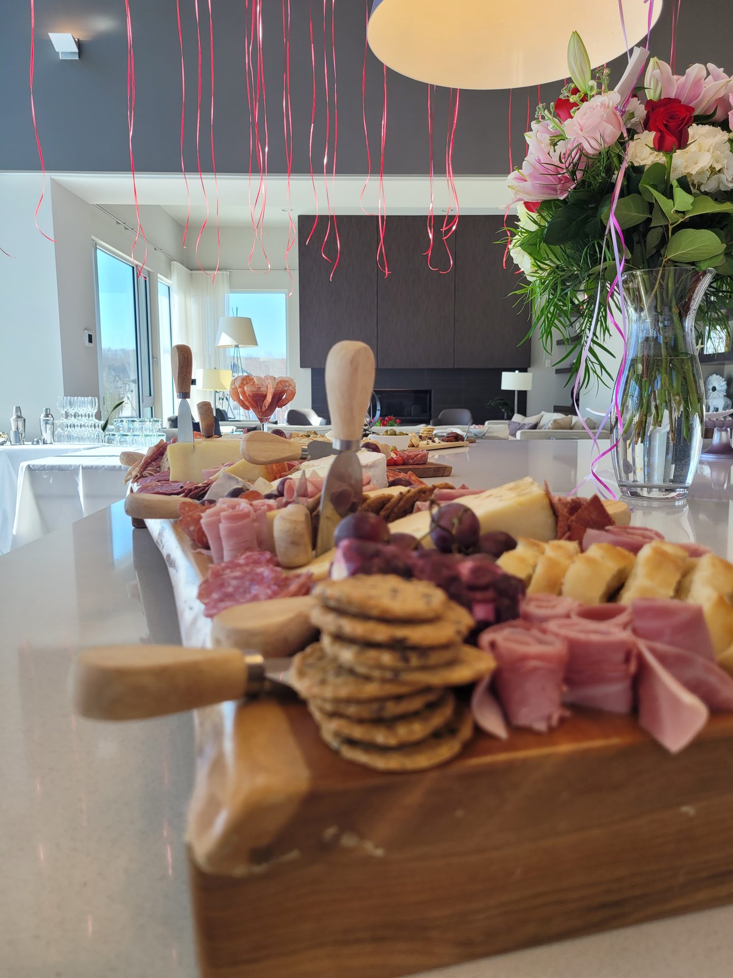 Celebration of life catering - charcuterie platter with floral arrangement