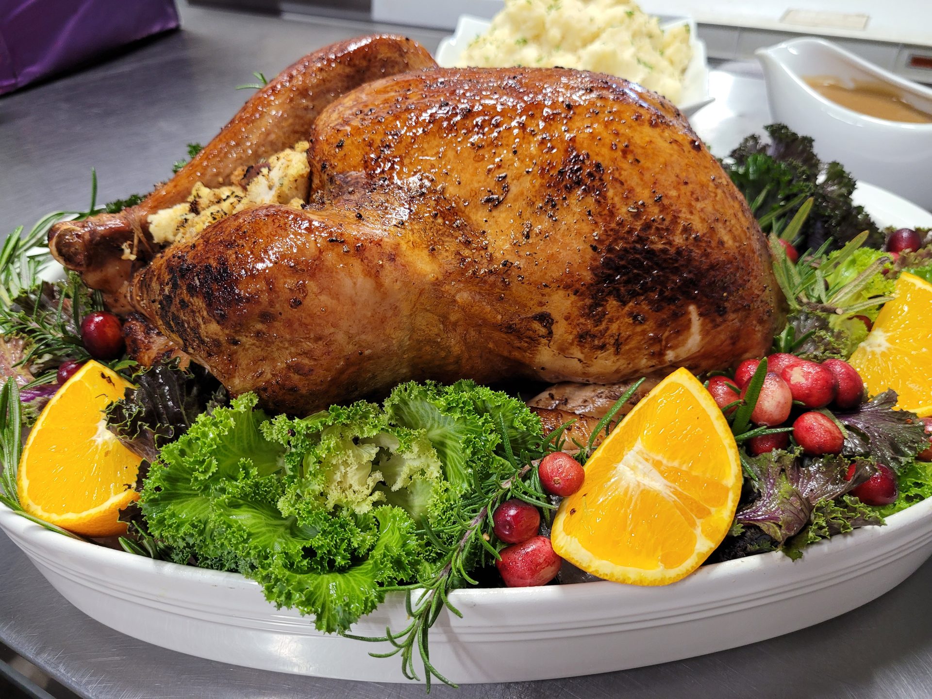 Herb-roasted whole turkey garnished with fresh rosemary and cranberries