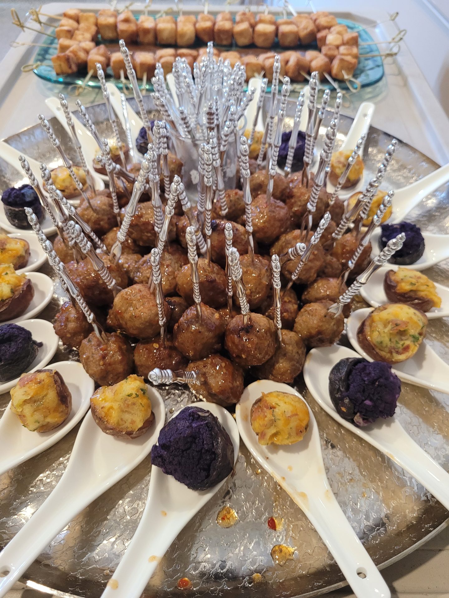Meatball canapés on Asian spoons with mini quiches