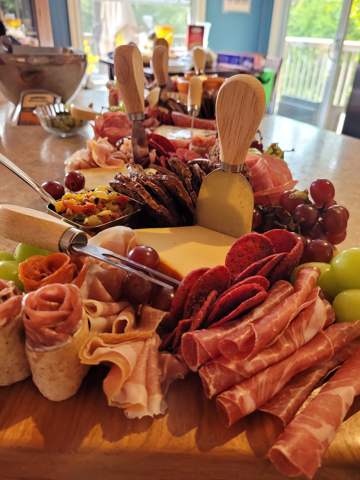 Artisan charcuterie board with prosciutto rosettes and aged cheeses